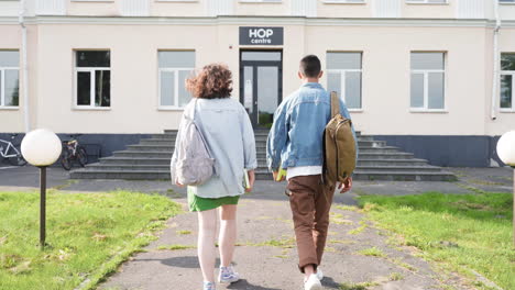 Two-friends-talking-outside-the-high-school