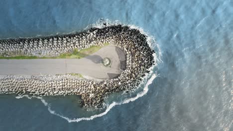 Aerial-top-view-panning-of-the-lighthouse-of-Farol-Do-Molhe-Da-Barra-De-ItajaÃ­,-Santa-Catarina,-Brazil