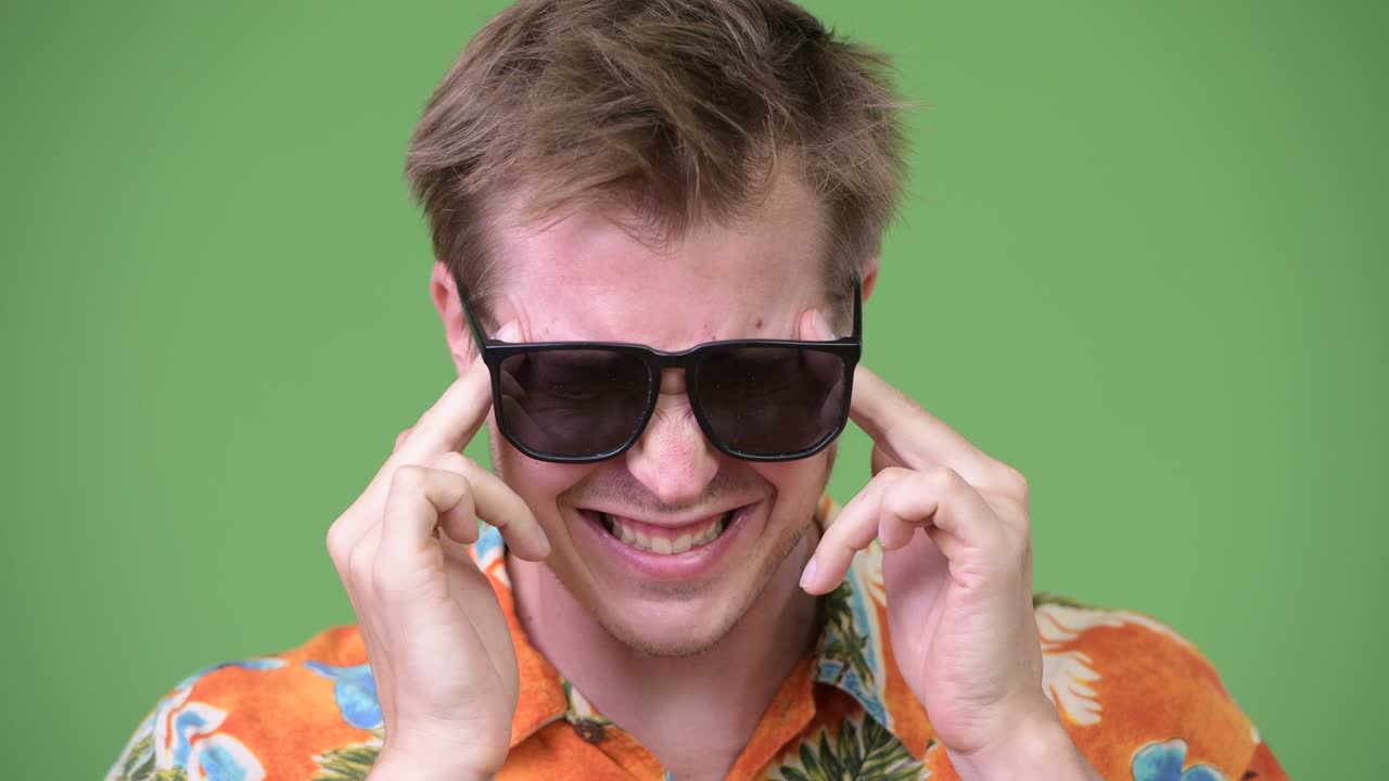 Young handsome tourist man having headache