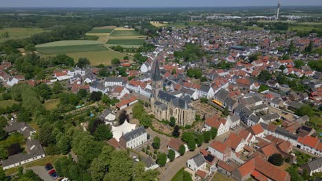 Wide-angle-drone-shot-of-the-municipality-of-maagouw,-thorn-in-the-province-of-limburg-with-a-view-of-the-Limburg-Abbes-Church,-Wijngaard,-historic-buildings-and-the-beautiful-flat-landscape