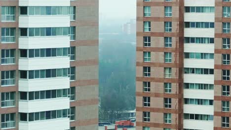 long lens captures riga skyline framed between high-rises with misty urban depth