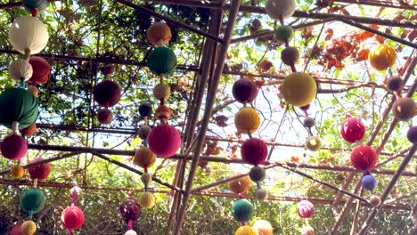 vibrant lanterns hanging in a lush garden