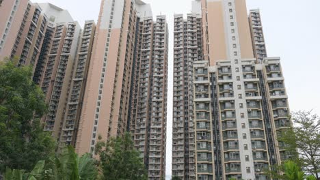 tilting shot of a high-rise public housing apartment building complex in hong kong