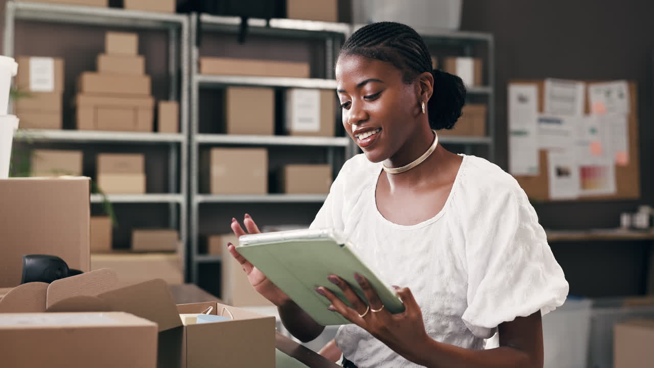 Happy Young Black Woman Working on Tablet in Small Business Office