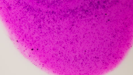 purple liquid sample with particles