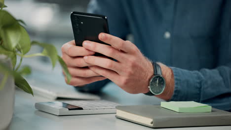 person using a phone at a desk