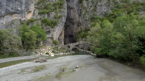 portitsa stone bridge and gorge in grevena greece, aerial dolly shot, panoramic view