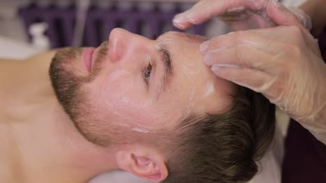 man receiving a facial treatment