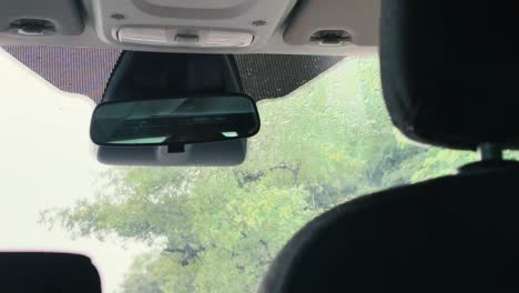 car interior with rainy windshield view