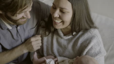 loving parents holding newborn baby