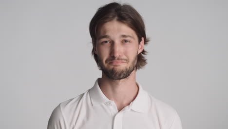 caucasian man in front of camera on gray background.