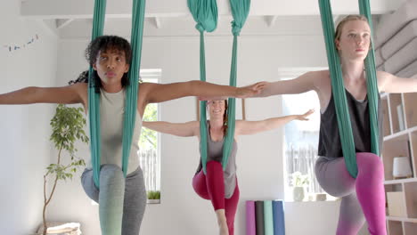 portrait of happy diverse female friends playing and talking at home, slow motion