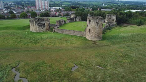 flint castle welsh medieval coastal military fortress ruin aerial view fast pull back establishing