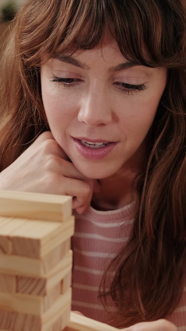 Woman Playing Jenga at Home