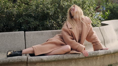 young woman resting on bench in the park.