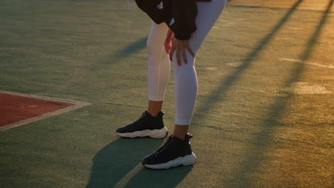 woman stretching on a sports court