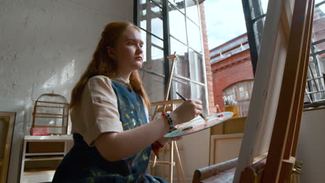 artist painting on a canvas