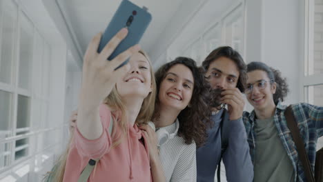 group of students taking a selfie in a school hallway