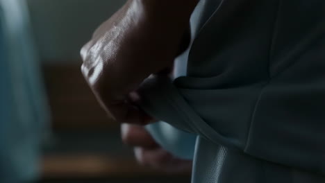 close-up of hands gripping light blue fabric