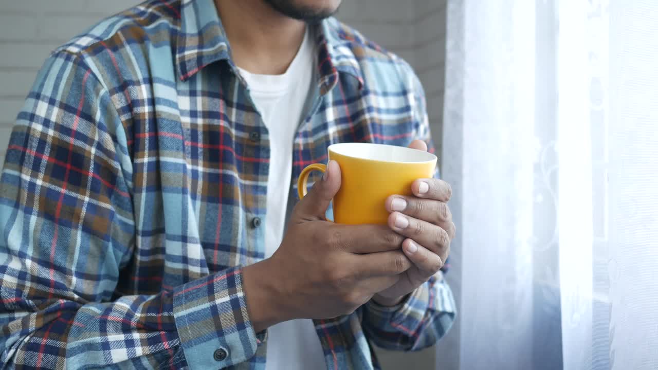hombre con una taza amarilla