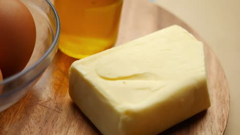 butter, honey and eggs on a wooden board