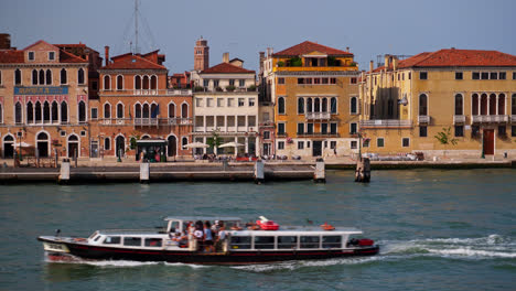 view of venetian architecture from boat sailing on the canal in venice italy - wide