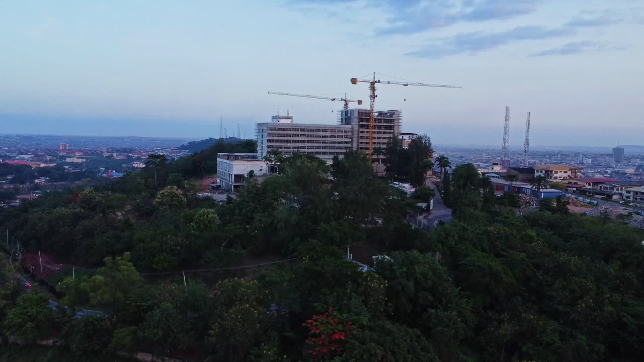Jib up of a beautiful hotel on a hill under construction overlooking the city of Ibadan, Nigeria