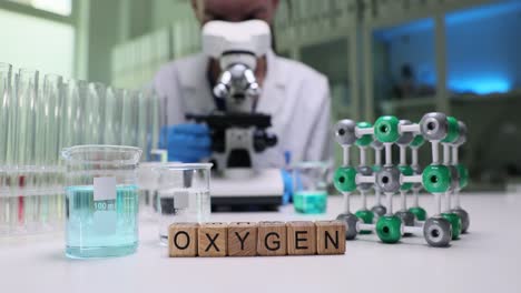 Scientist conducting research in a chemistry laboratory with an oxygen molecular model
