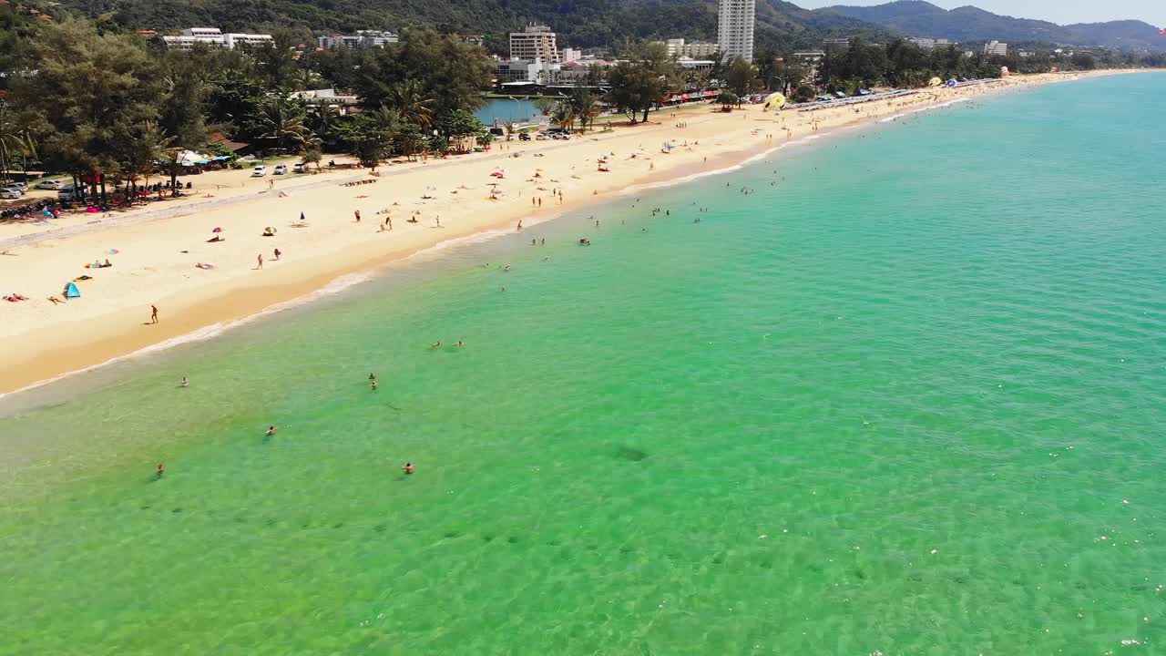 Aerial view of beachgoers enjoying popular beach in Phuket, Thailand