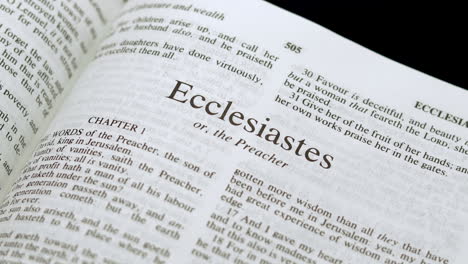 close up shot of bible page turning to the book of ecclesiastes