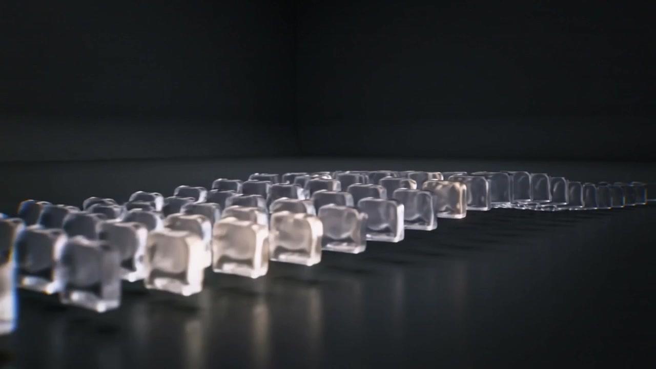 Appearing warm highlight traveling across glass blocks on glossy dark table, revealing glints