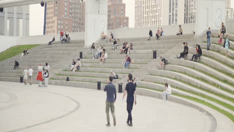 city park with people relaxing on amphitheater seating