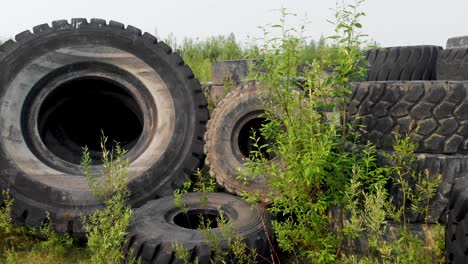 4k drone video of discarded giant excavator tire pile in wilderness near fairbanks, ak during summer day-5