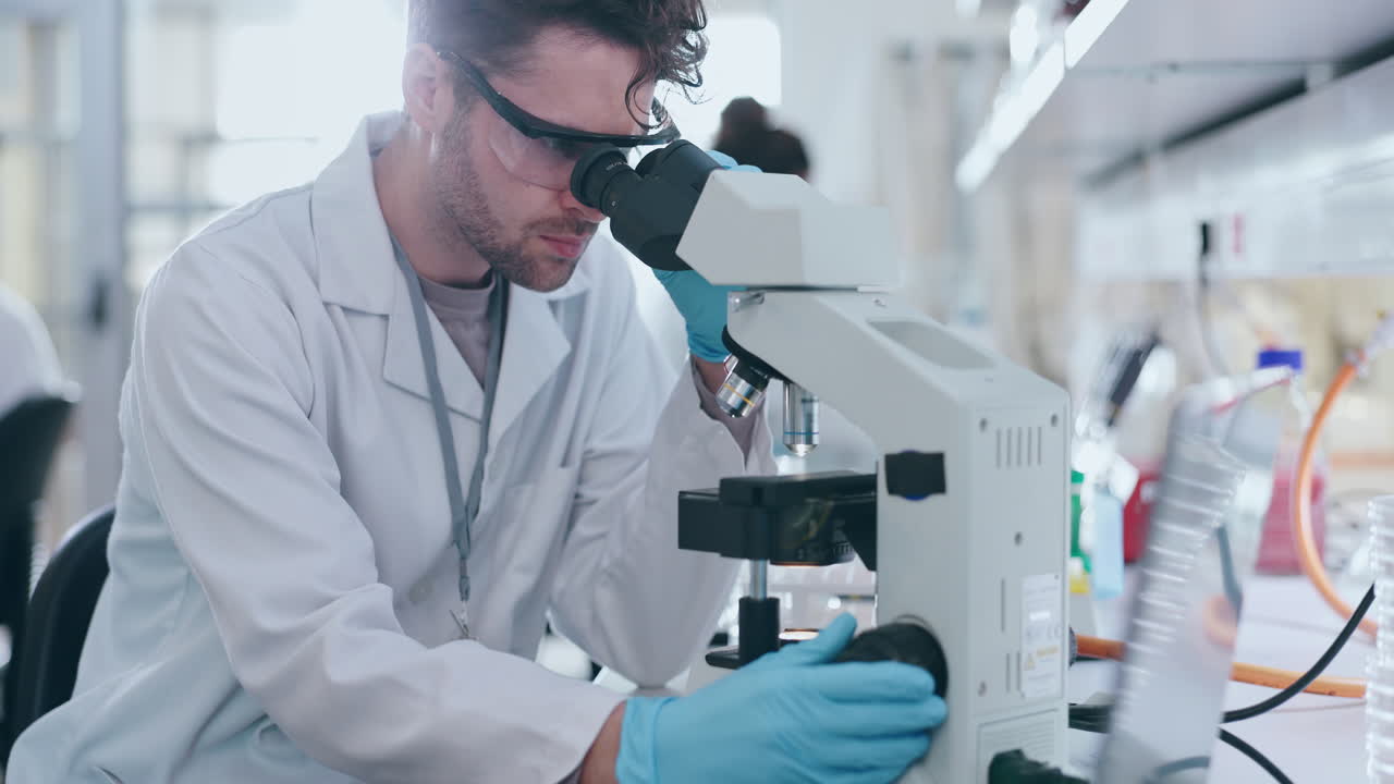 Microscope, science and man in laboratory