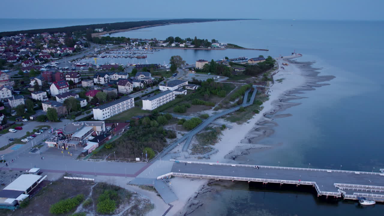 Drone tilt-up view over pavilion and Jastarnia port, Poland