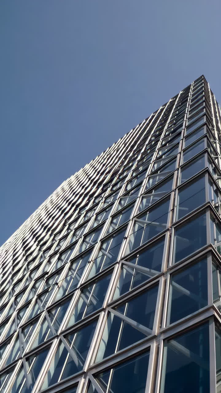 Modern Glass Skyscraper Against a Clear Blue Sky