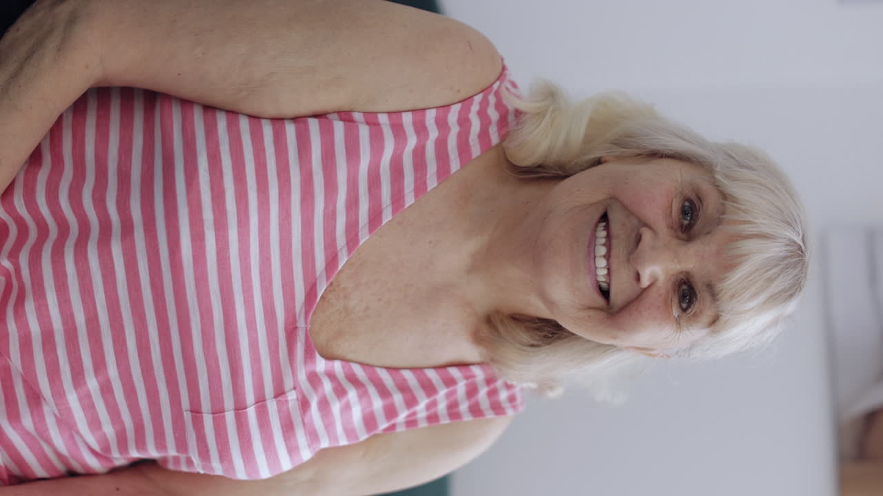Happy calm senior woman smiling dreaming resting relaxing good news feel satisfied at home chair