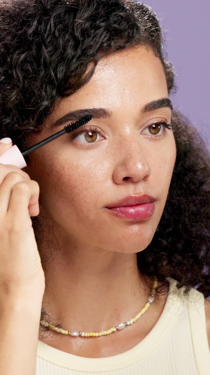 Woman applying mascara