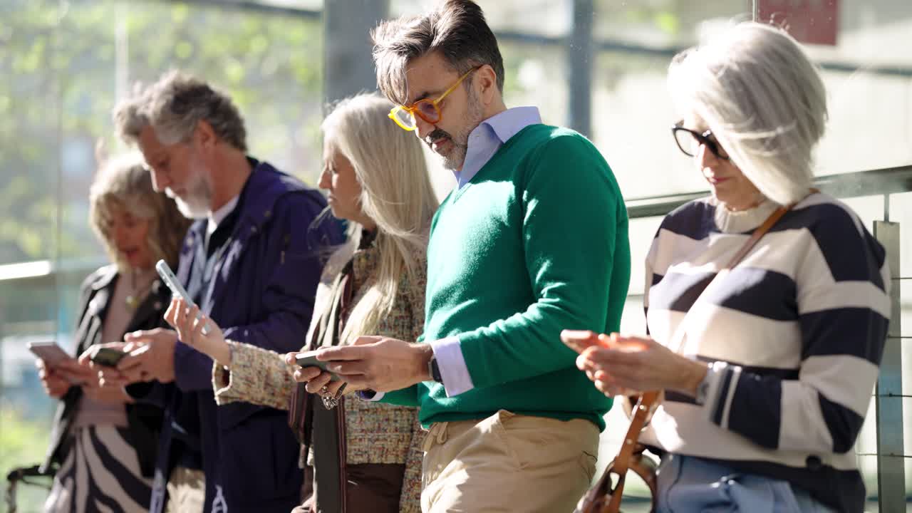 People using smartphones outdoors