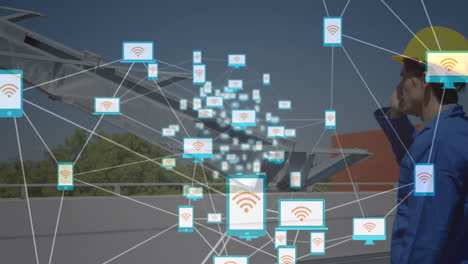 animation of network of connections over solar panels and caucasian male engineer