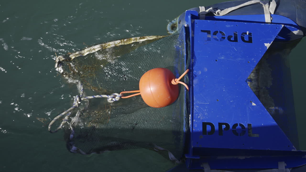 Villeneuve-Loubet, France - June 7, 2025: Close up of a floating marine debris collection device in the water