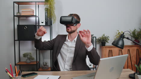 Businessman-working-using-virtual-reality-futuristic-technology-VR-app-headset-helmet-at-home-office