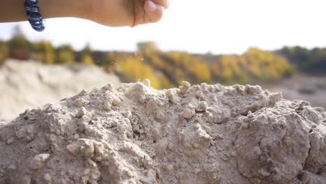 hand throwing sand