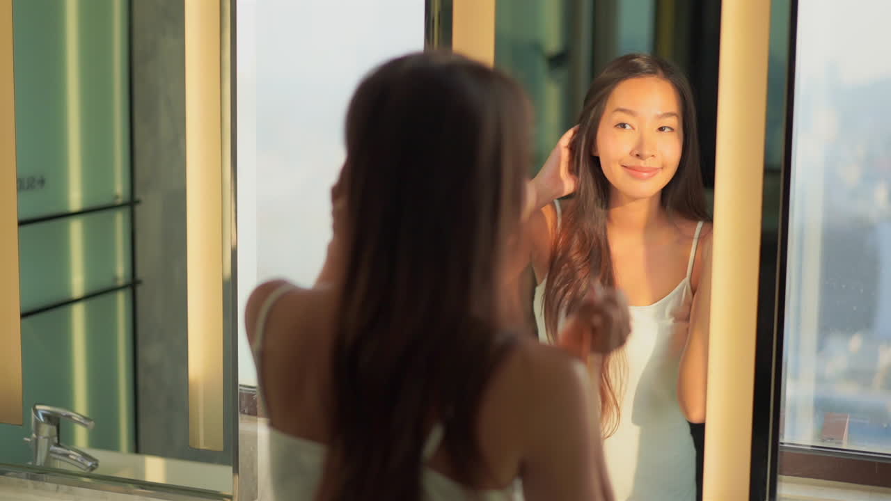 Quarantine asian self care applying eyeliner in the mirror