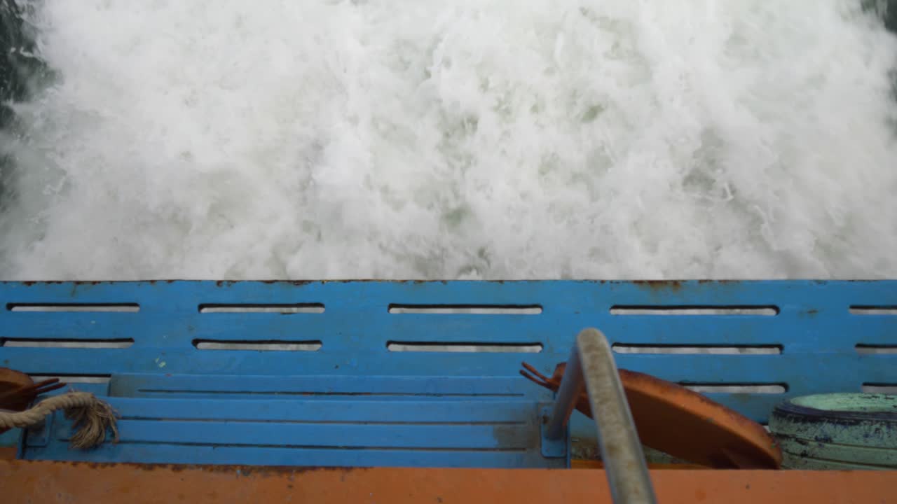 Overhead Of A Ferry Boat Cutting Through Ocean Waters, Churning Waves Visible Below. High Angle Shot