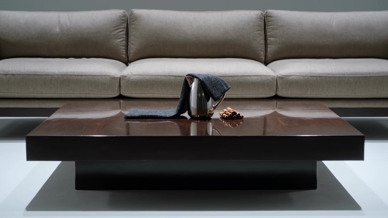 Zooming camera revealing kettle, dark cloth and nuts on table at home, showing shine and folds