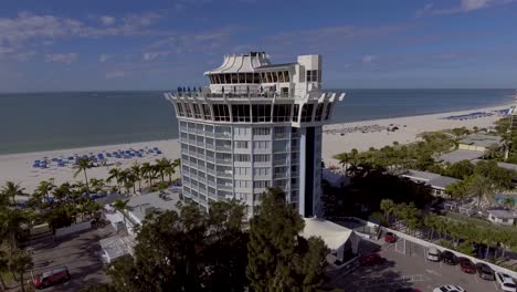 4k drone video of round bellwether resort building on the gulf of mexico in st