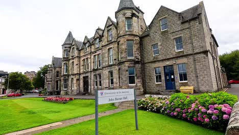 stone architecture with lush greenery and signage