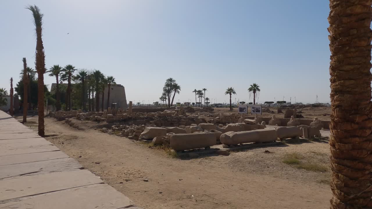 Looking Across Open Field With Rows Of Stonework From Luxor Temple Complex