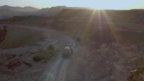 drone following a water tanker truck with rays
